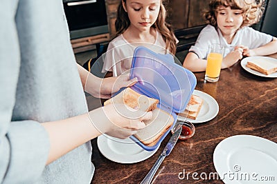 mother packing school lunch in box Stock Photo