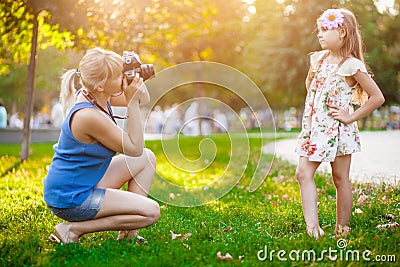Mother photographing her daughter Stock Photo