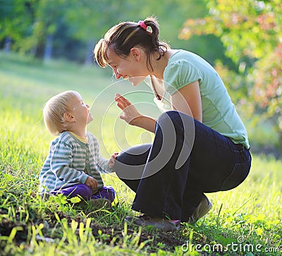 Mother play with her baby outdoor Stock Photo