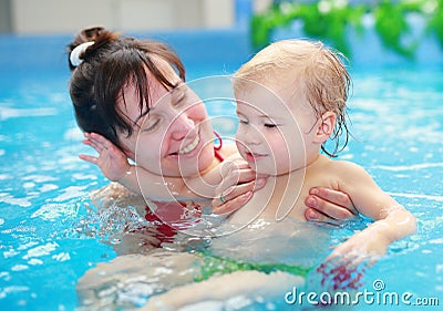 Mother play with her child in swimming-pool Stock Photo