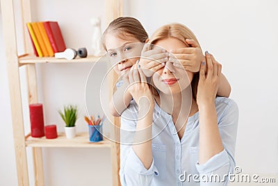 Mother playing with her daughter at home Stock Photo