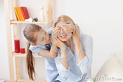 Mother playing with her daughter at home Stock Photo