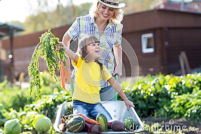 Mother playing with kid in garden in village Stock Photo