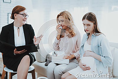 Mother with Pregnant Daughter in Doctor Office. Stock Photo