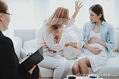 Mother with Pregnant Daughter in Doctor Office Stock Photo