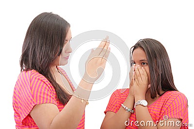 Mother preparing to slap her daughter in the face Stock Photo