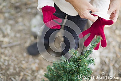 Mother Putting Red Mittens On Child Outdoors Stock Photo