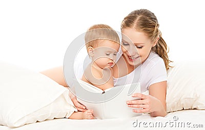 Mother reading book baby in bed before going to sleep Stock Photo