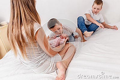 Mother reveals older baby`s baby at home Stock Photo