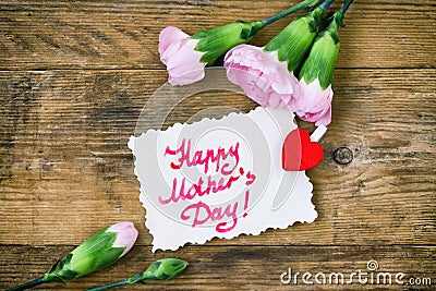 Mother`s Day card, pink carnations and note Stock Photo