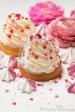 Mother`s day holiday brunch with cupcake craem and pink flowers on white background Stock Photo