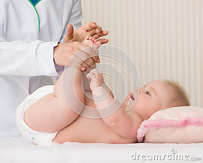 Mother massaging baby Stock Photo