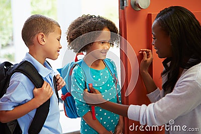 Mother Saying Goodbye To Children As They Leave For School Stock Photo