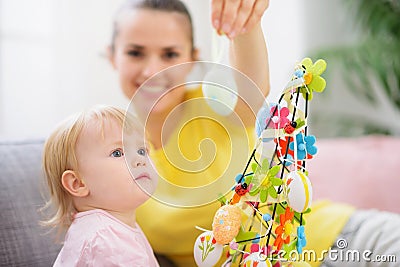 Mother showing baby Easter egg Stock Photo