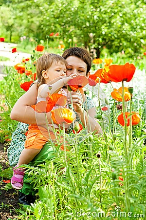 Mother showing flowers to daughter Stock Photo