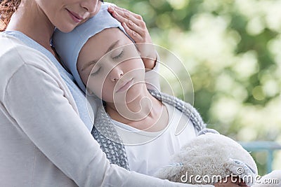 Mother and sick teenager daughter with cancer in the garden of home hospice Stock Photo