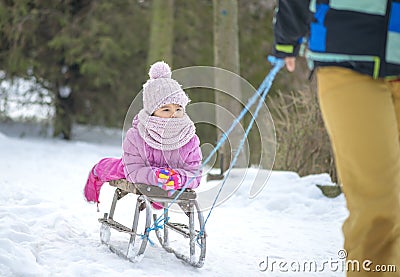 Mother sledding his little girl on an old sled Stock Photo