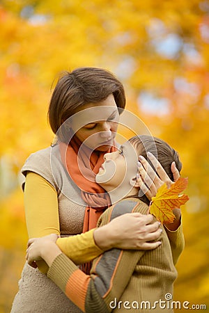 Mother with son in autumn park Stock Photo