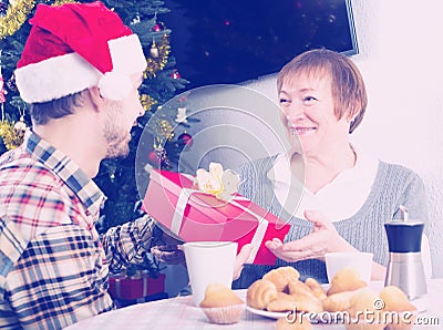 Mother and son exchanging Christmas gifts Stock Photo