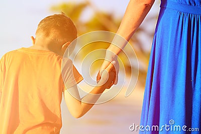 Mother and son holding hands on beach Stock Photo
