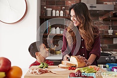 Mother And Son Making School Lunch In Kitchen At Home Stock Photo