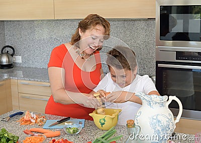 Mother and son preparing lunch using eggs and laugh Stock Photo