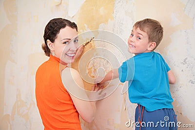 Mother with son remove old wallpapers Stock Photo