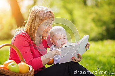 Mother with son sitting and read fairytale Stock Photo