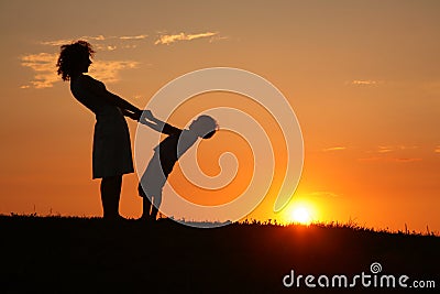 Mother and son on sunset holding by hands Stock Photo