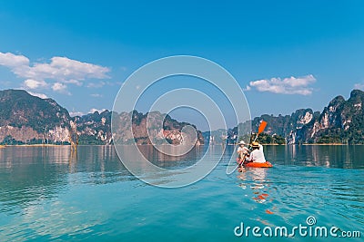 Mother with son together floating on kayak by the Cheow Lan lake in exotic Thailand. Traveling with kids concept image Stock Photo