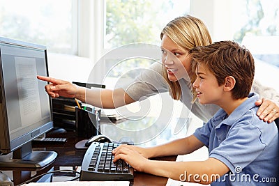 Mother and son using computer at home Stock Photo