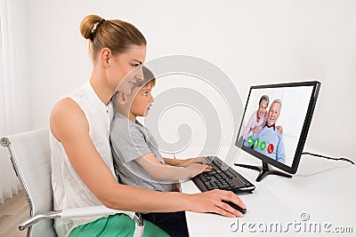 Mother And Son Videoconferencing Stock Photo