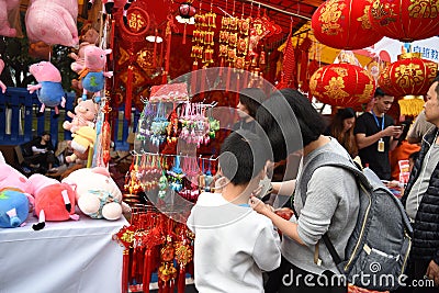 A mother and a son is visiting the Chinese new year market Editorial Stock Photo