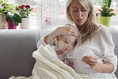 Mother staying at home with her sick child Stock Photo