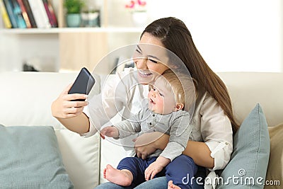 Mother taking a selfie with her baby son Stock Photo