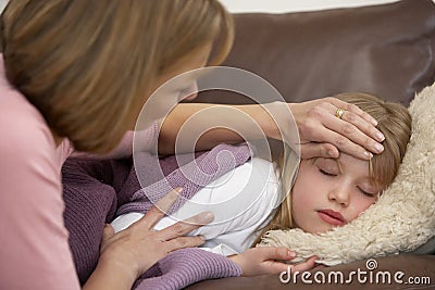 Mother Taking Temperature Of Sick Daughter Stock Photo