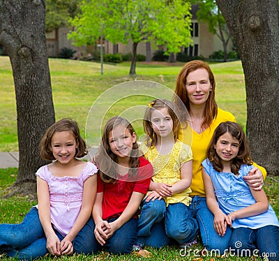 Mother teacher with daughter pupils in playground park Stock Photo