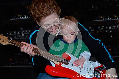 Mother Teaches Child Guitar Music Lesson Stock Photo