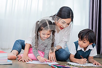 Mother teaching children in drawing class. Daughter and son pain Stock Photo