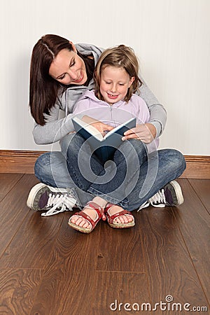 Mother teaching daughter to read home education Stock Photo