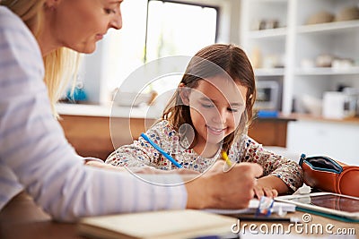 Mother teaching her daughter at home Stock Photo