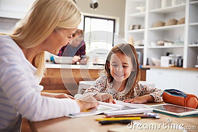 Mother teaching her daughter at home Stock Photo