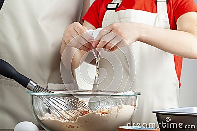 A mother is teaching her little daughter how to cook. Stock Photo