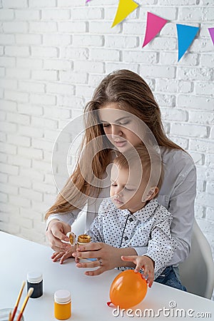 Mother and her little son learning to paint Stock Photo