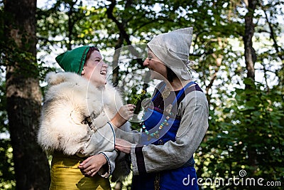 Mother and teenage daughter communicate and laugh. woman and girl in antique viking clothes. Stock Photo