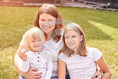 Mother with teenage daughter and little son. Outdoor family portrait. Three Stock Photo