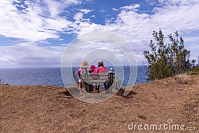 A mother and three kids sitting on a bench at a viewpoint at Ohai trail. Editorial Stock Photo