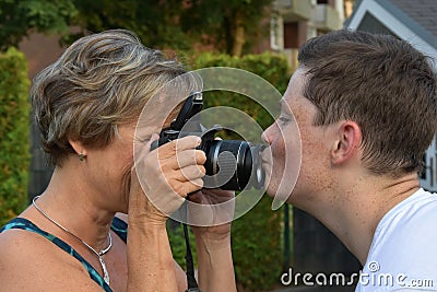 Mother tries to take photos of her teenager son Stock Photo