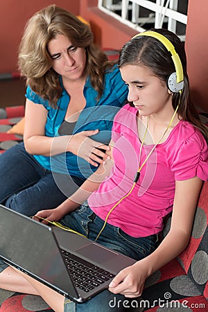 Mother tries to talk to her internet addicted daughter Stock Photo