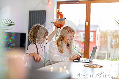 Mother trying to work from home with her son Stock Photo
